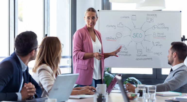 young-businesswoman-pointing-at-white-blackboard-a-2024-09-17-21-21-49-utc