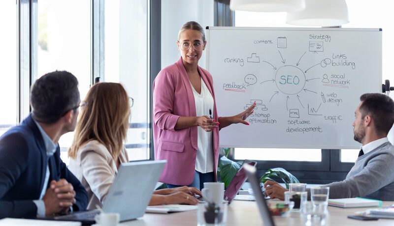 young-businesswoman-pointing-at-white-blackboard-a-2024-09-17-21-21-49-utc